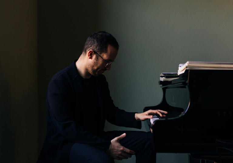 Igor Levit sitting at piano 