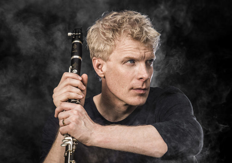 martin Frost holding clarinet smoke