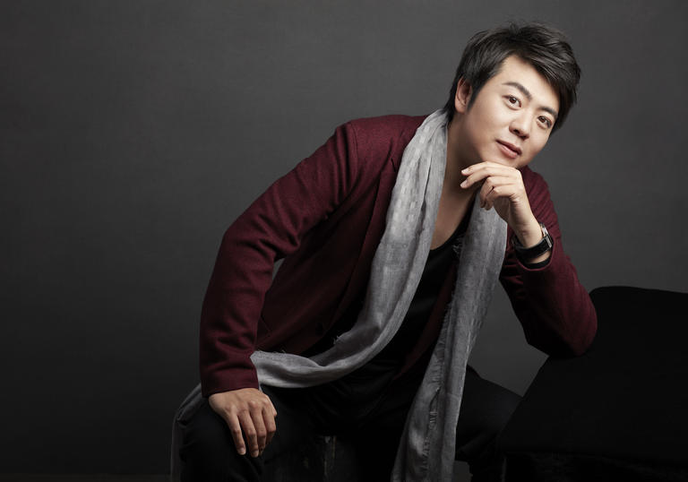 Lang Lang leaning on piano