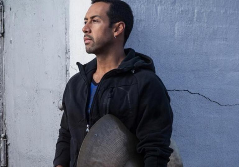 Antonio Sanchez holding a cymbal