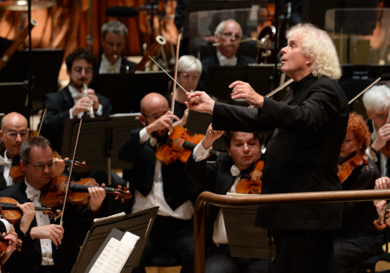 photo of simon rattle conducting