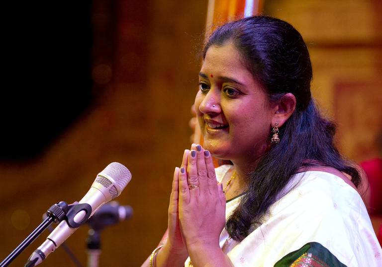 Mankiri Asnare presses her hands together as she sings