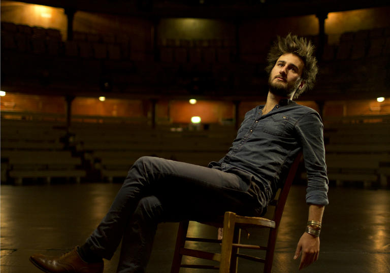 Jean Rondeauc leaning on chair on stage portrait