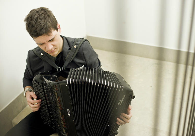Joao Barradas playing accordion in stairwell