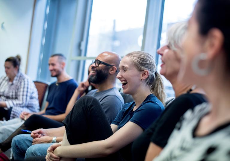 teachers sit smiling