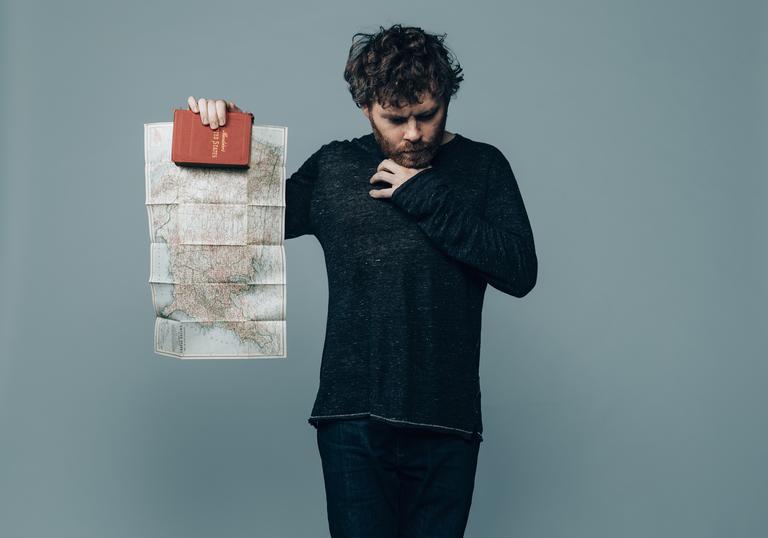 Gabriel Kahane holds up a map of North America