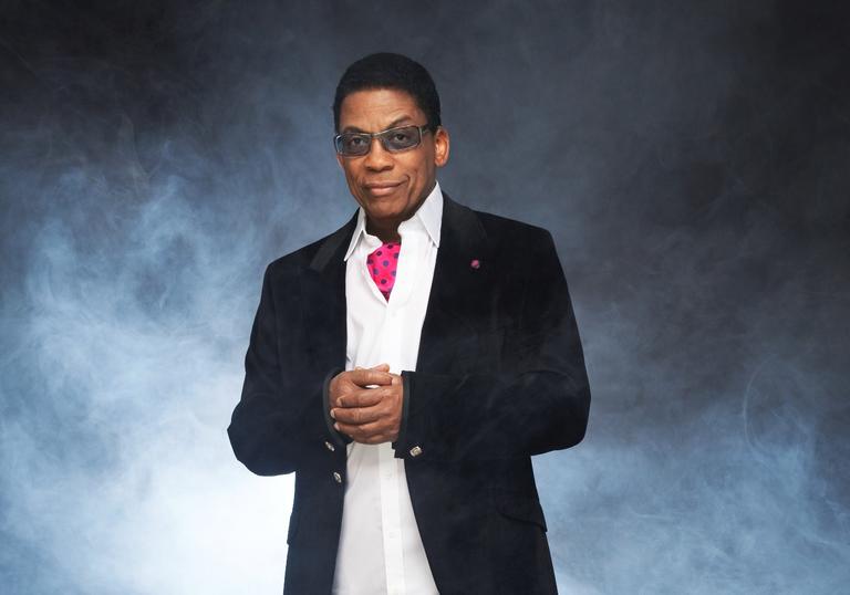 Herbie Hancock wearing a suit and pink cravat