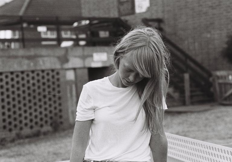 Lucy Rose pictured in black and white looking down