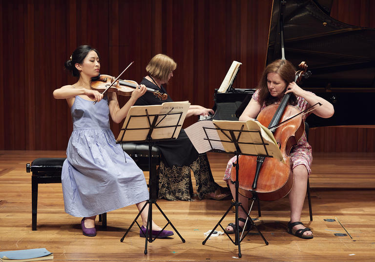 Piano trio performing on stage