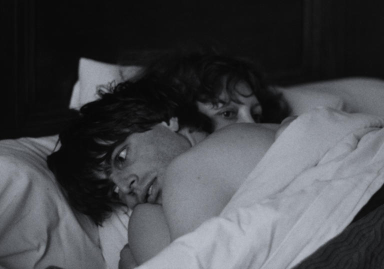 Photo of a couple embracing in bed