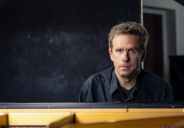 Guildhall Professor David Dolan sitting at the piano