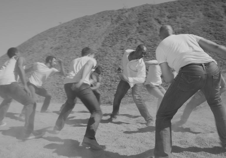 A monochrome picture of dancers in a circle