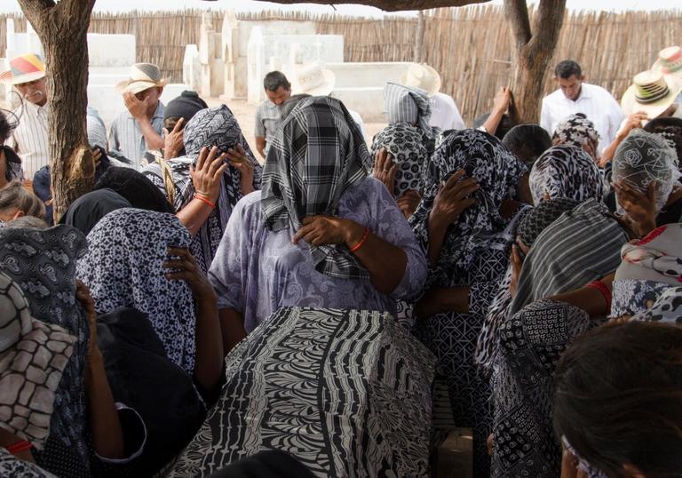A crowd with scarves on their heads