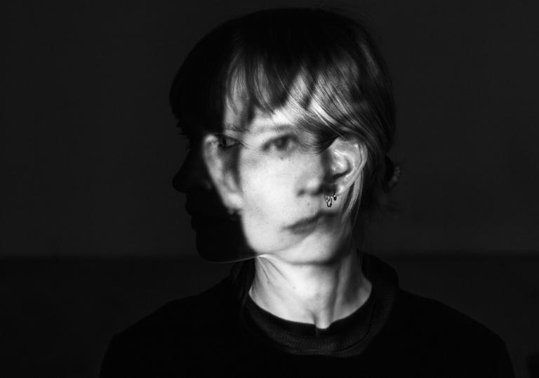 A black and white photo of Jenny Hval with her face distorted