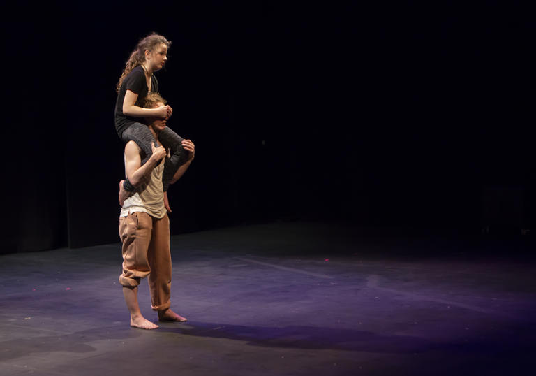A person sitting on someone else's shoulders