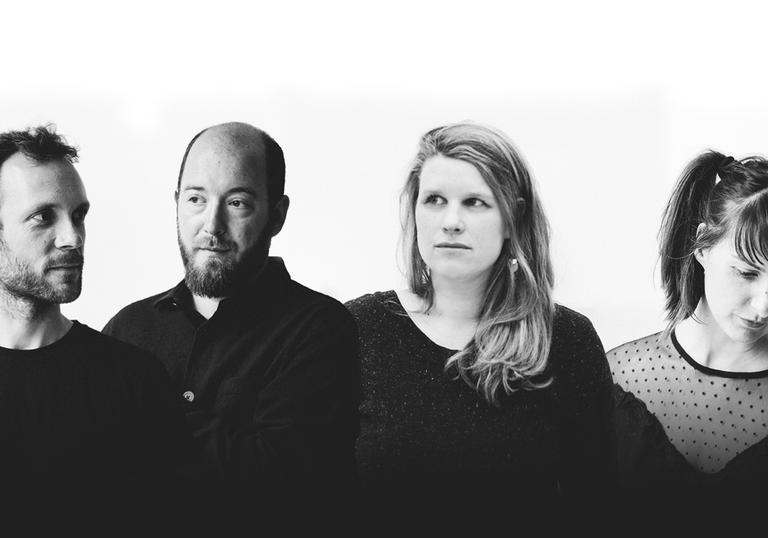 Echo Collective wearing black clothing against a white background