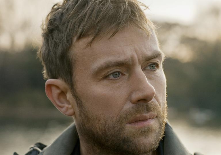 A headshot of Damon Albarn looking to the distance