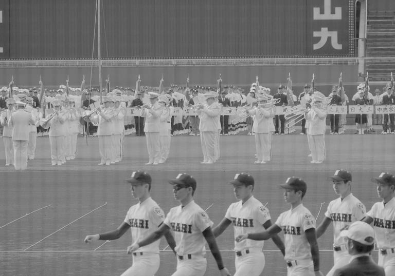 men marching in caps and sportswear