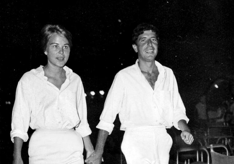 marianne and leonard walking together both wearing all white