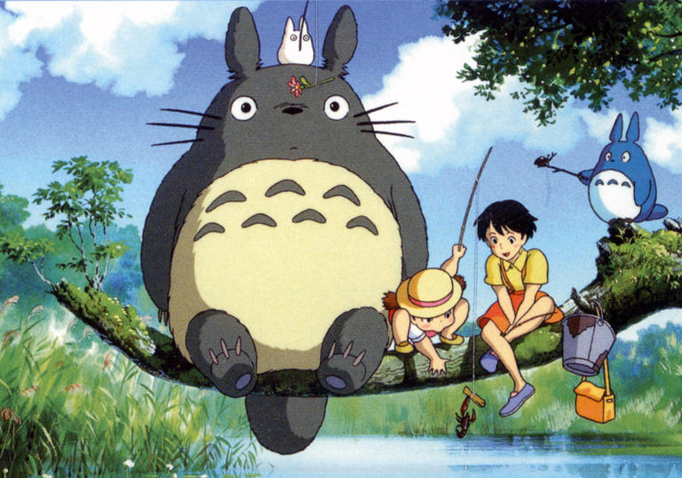 Totoro and children sitting on a branch above a river