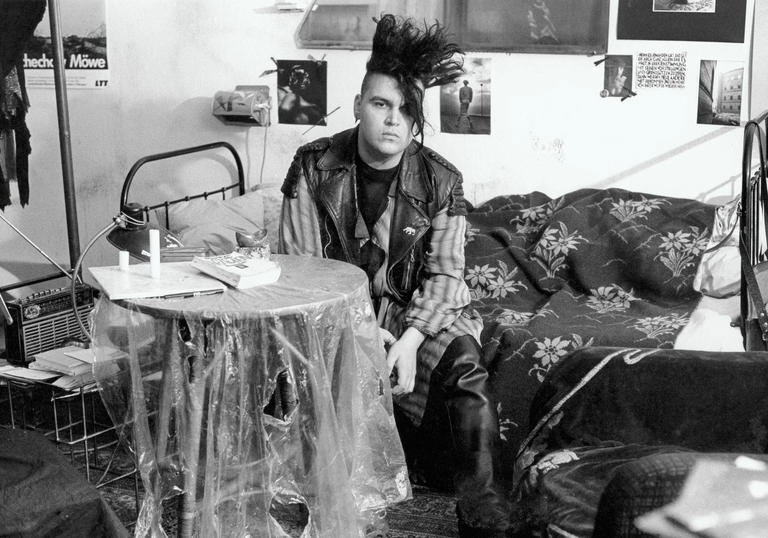 punk man sitting at a table