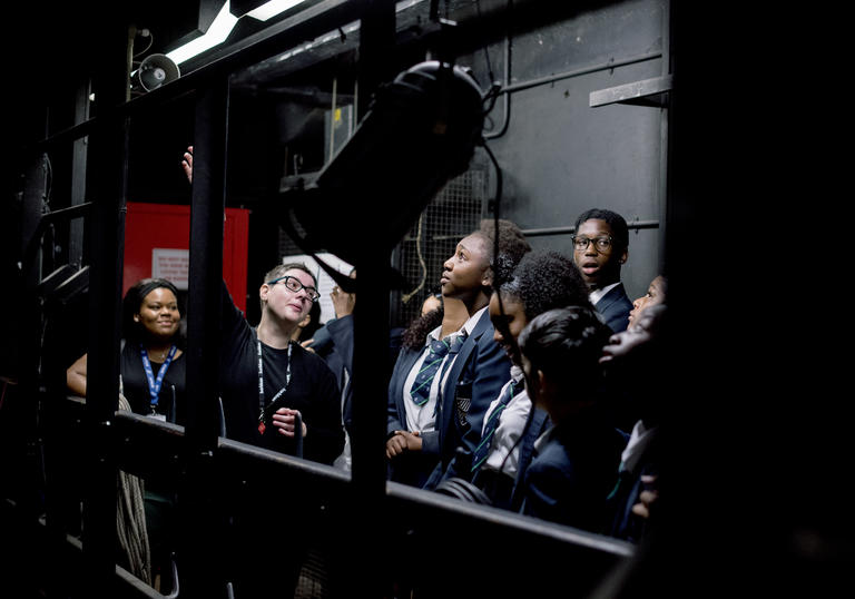 A group of school students backstage at the Barbican Theatre