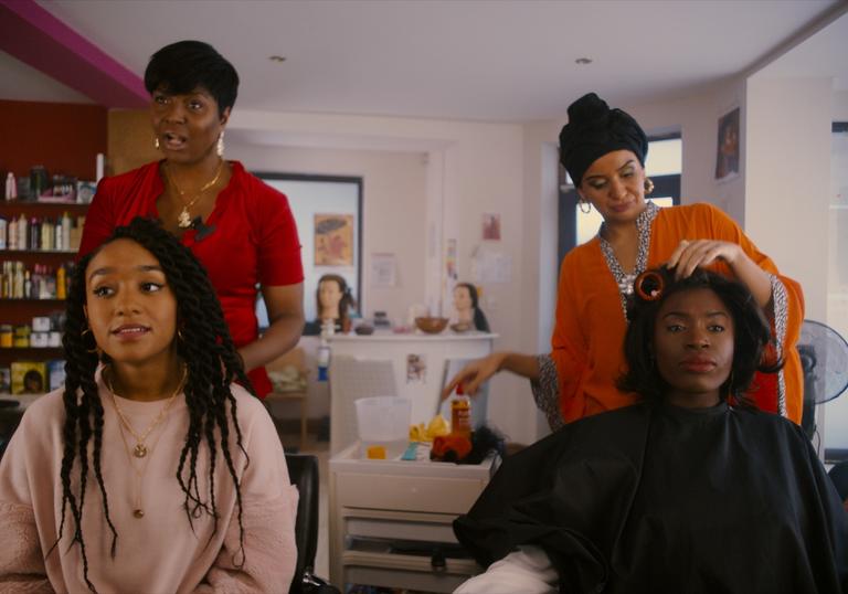 four women in a hairdressers shop