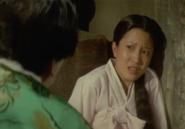 woman shouting at another woman wearing traditional Korean dresses