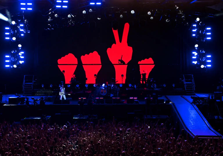 Depeche Mode on stage with blue and red lights