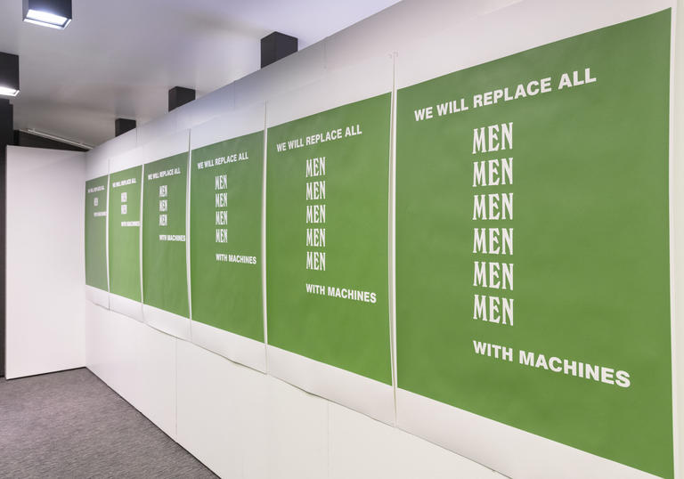 An image of Nina Wakeford's green 'We Will Replace All Men With Machines' poster