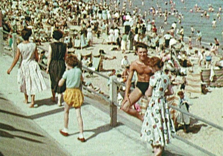 An image of holiday makers on a beach in Scotland