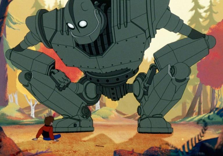 the iron giant crouching over a young boy