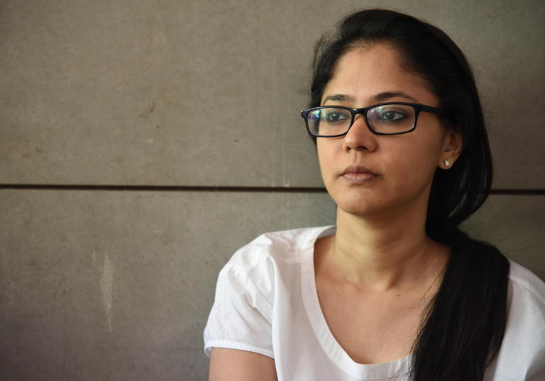photo of a woman wearing glasses and a white tshirt