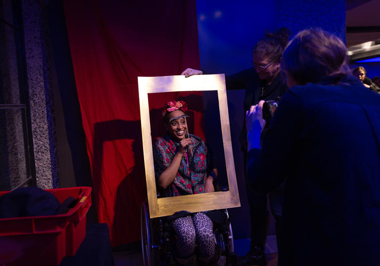 Woman smiling behind a frame