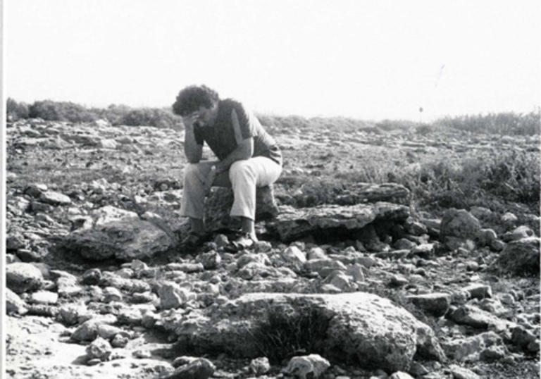 Man sitting in a deserted plain