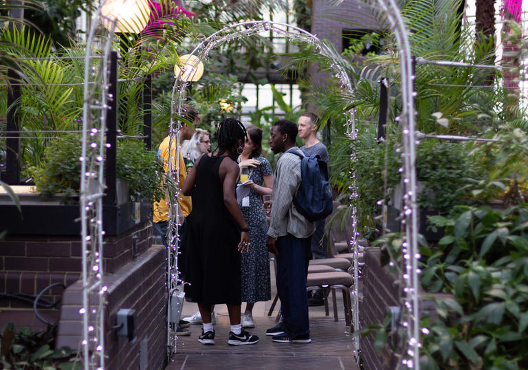 Group of people talking in the barbican conservatory 