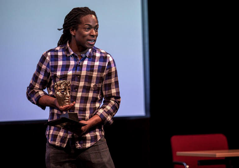 Nigel Clarke holding a BAFTA award