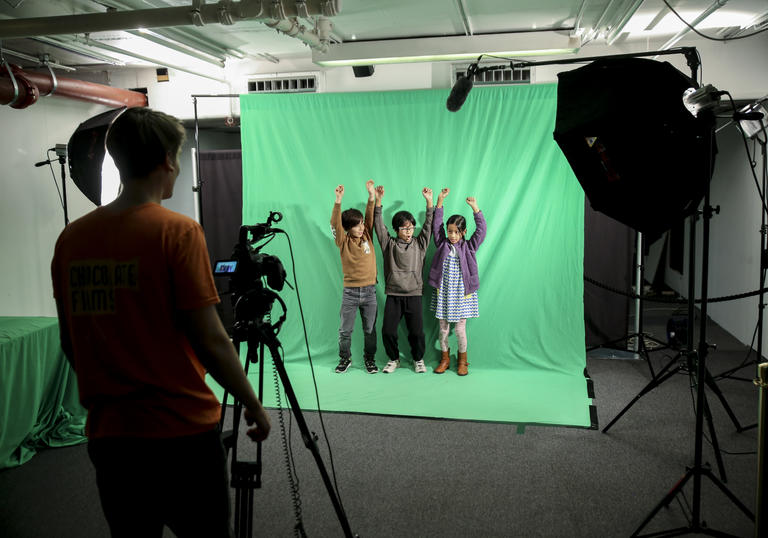 Three children act on a green screen 