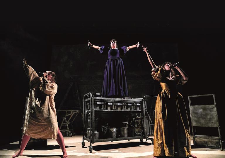 three women triumphantly sing