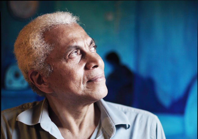 photo of Paulinho da Viola showing his head and shoulders framed against a background of different shades of blue