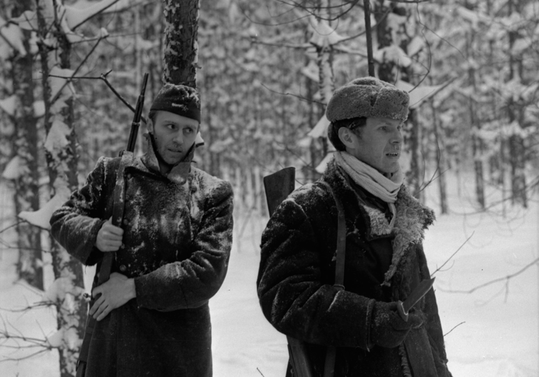 Two Russian soldiers walk through snowy woods in The Ascent