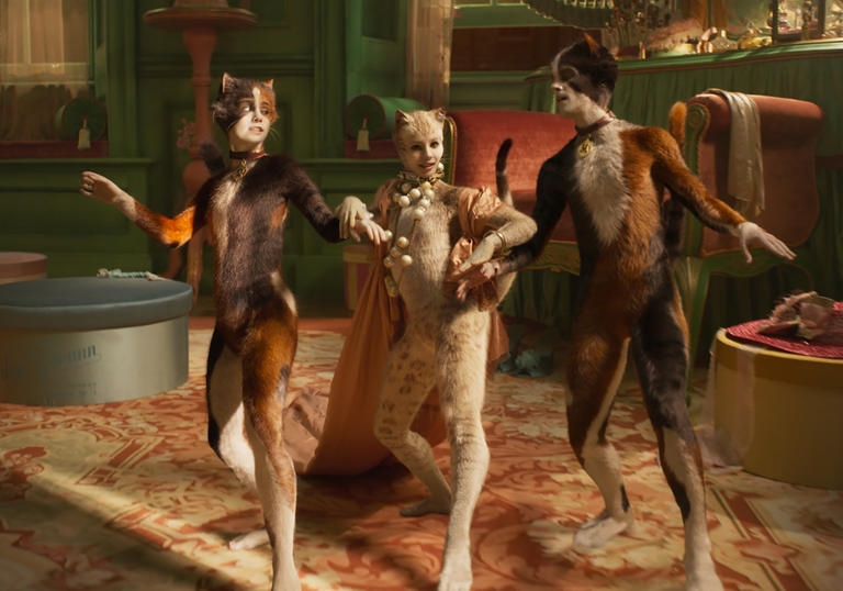 francesca hayward and two other cats dance around large furniture