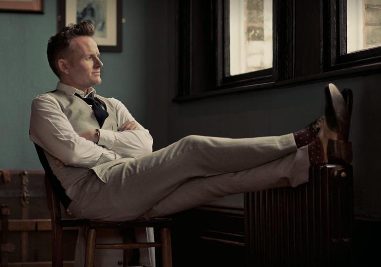 Joe Stilgoe pictured sitting down with feet up and arms crossed