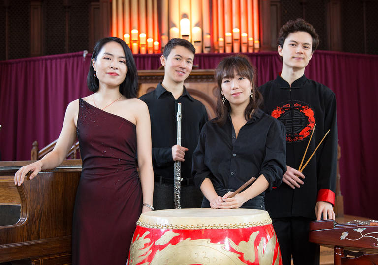 Members of Tangram stand together with their instruments.