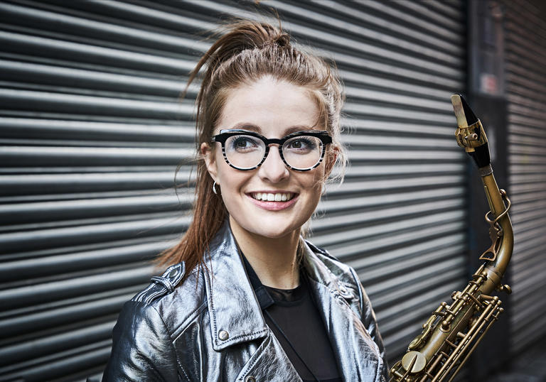 Jess Gillam smiling happily in anticipation of her concert at the lso