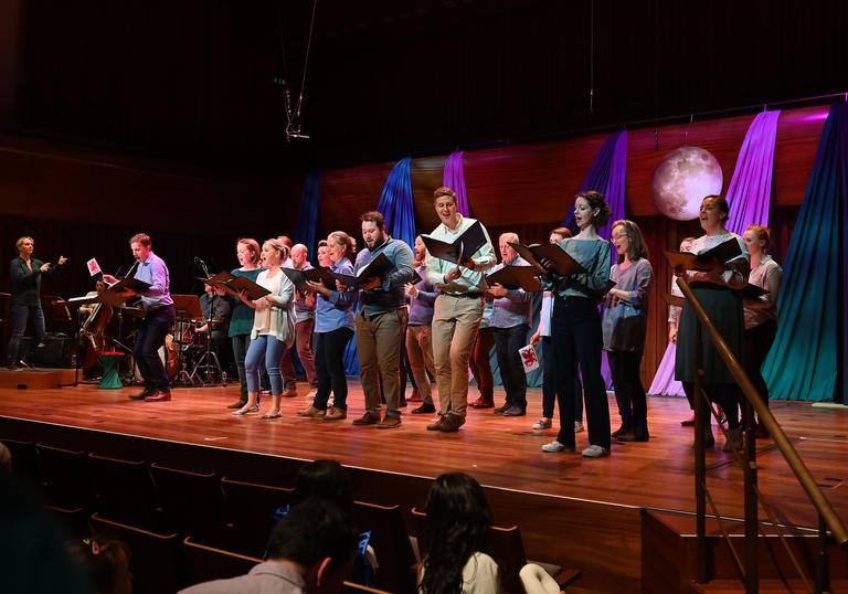 The BBC singers singing joyfully 