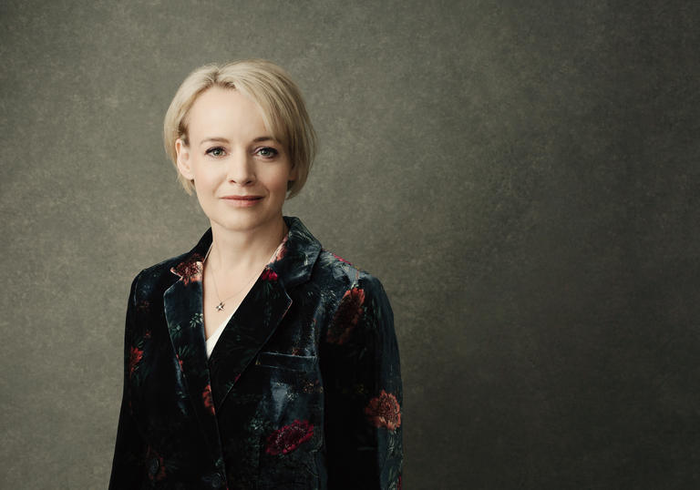 A portrait of Rachel Nicholls wearing a floral velvet blazer