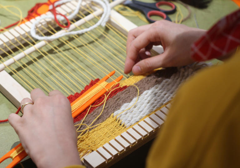 Woman using weave to make textile