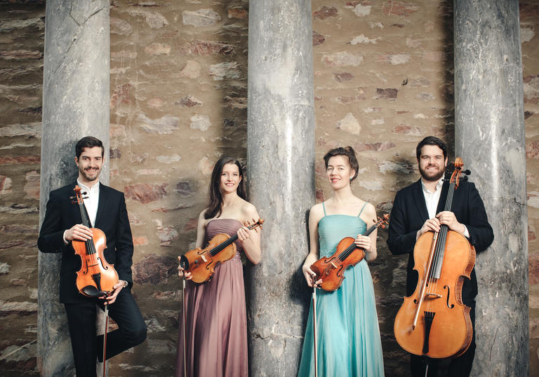 The Aris Quartet posing with their instruments 