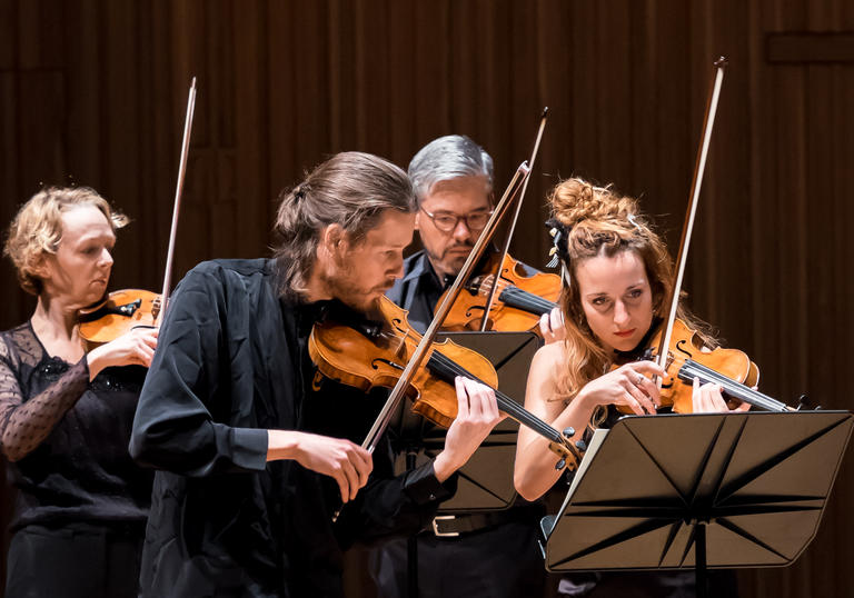 An image of the Britten Sinfonia musicians playing their instruments 